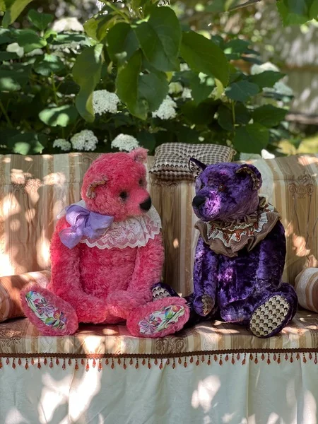 Handmade teddy bears speak in garden