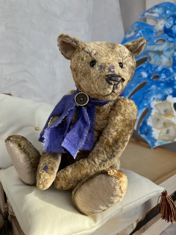 Handmade vintage plush bear with blue ribbon